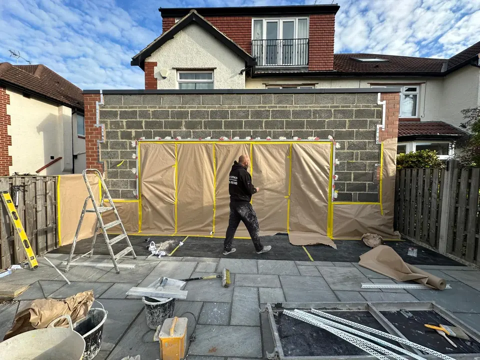 Single-storey blockwork extension masked up before rendering
