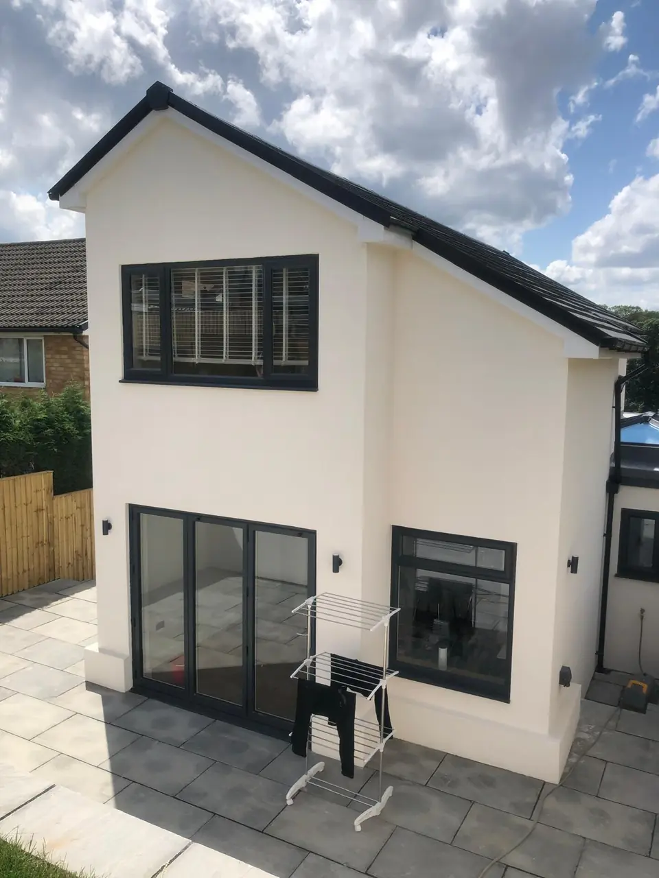 Rear of a modern detached house with a clean white render finish
