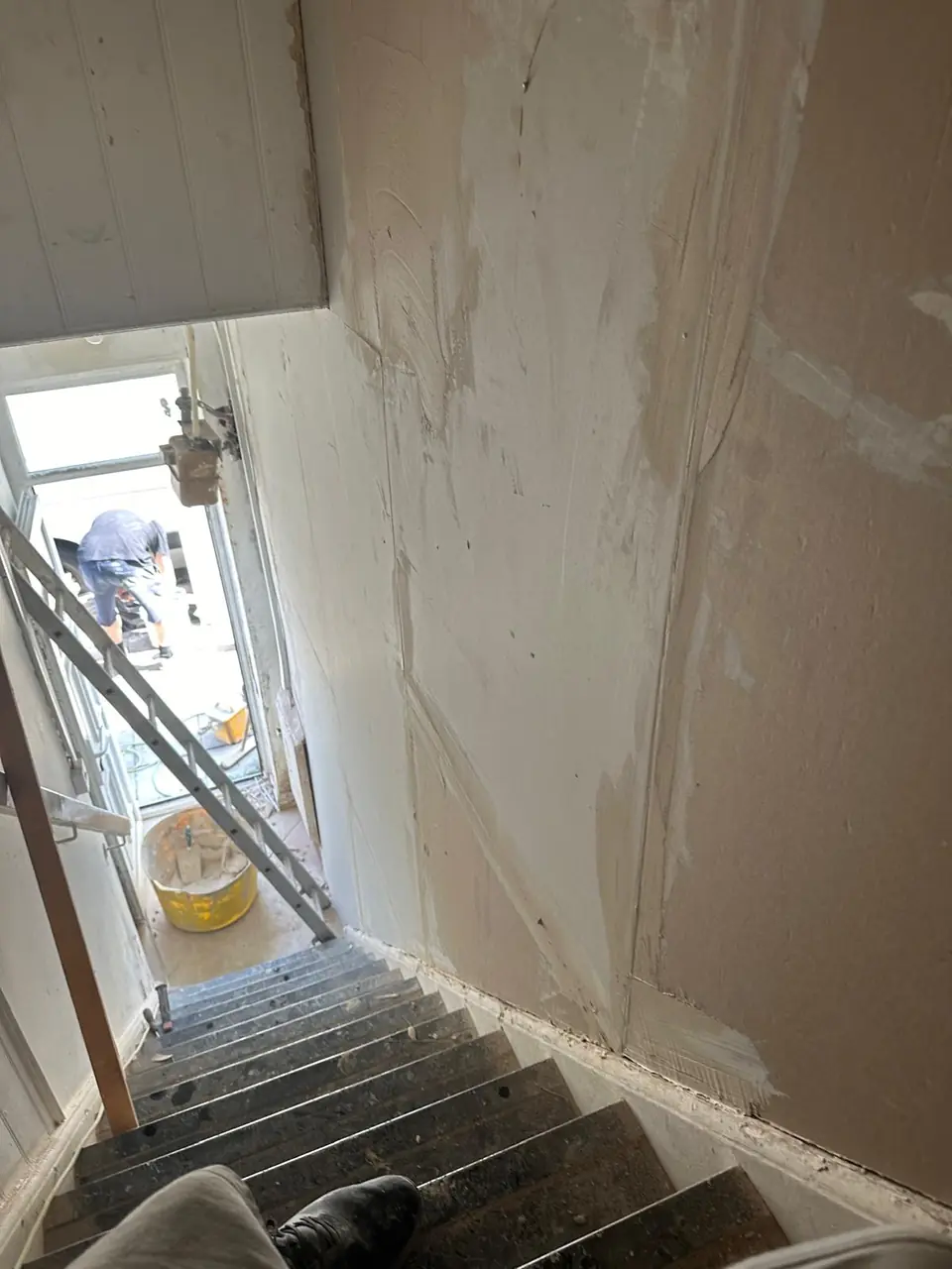 Stairwell walls stripped back and being prepared for cork plaster